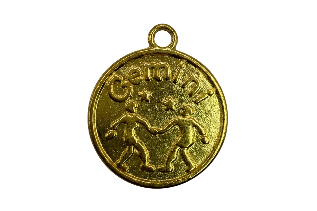 Gold round Gemini zodiac coin medallion with twin figures and star details