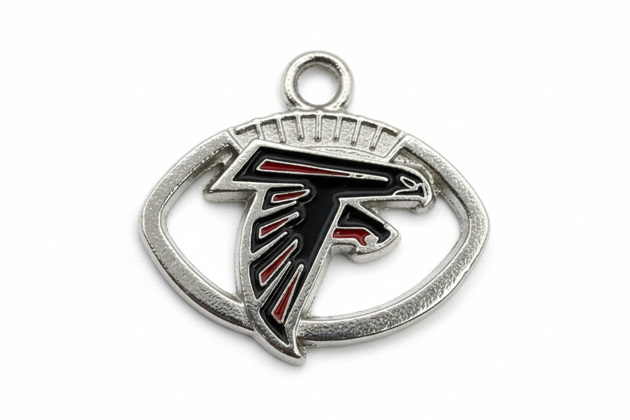 Silver oval falcon head emblem with black enamel and red accents