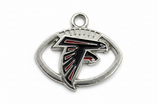 Silver oval falcon head emblem with black enamel and red accents