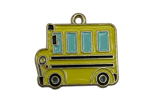 Yellow enamel school bus charm with blue windows and gold outline