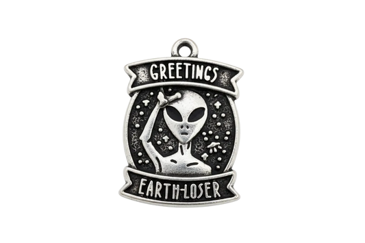 Antique silver alien badge with black background and banner text, retro sci-fi style