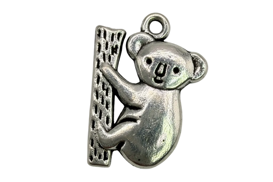 Oxidized silver koala clinging to a textured tree trunk charm