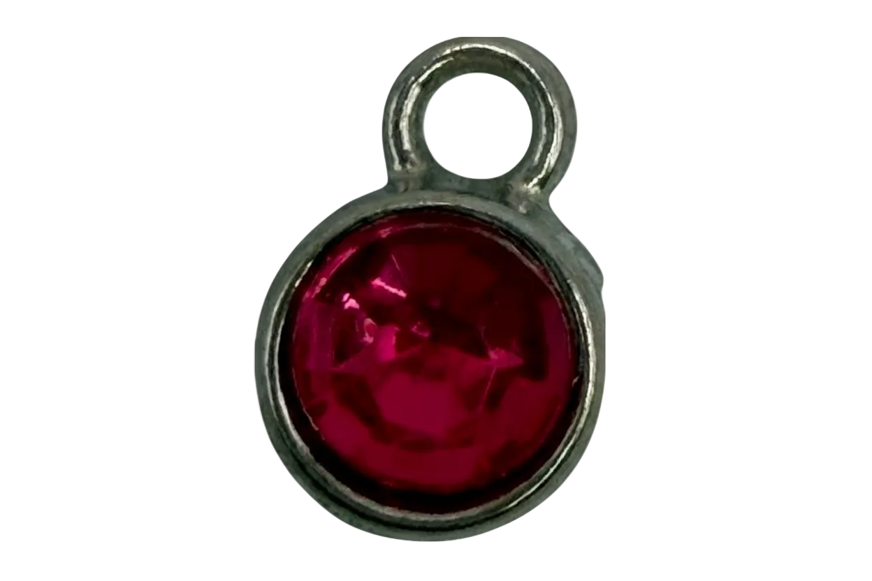 Faceted fuchsia round gem framed in polished silver-tone metal