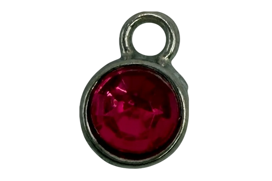 Faceted fuchsia round gem framed in polished silver-tone metal