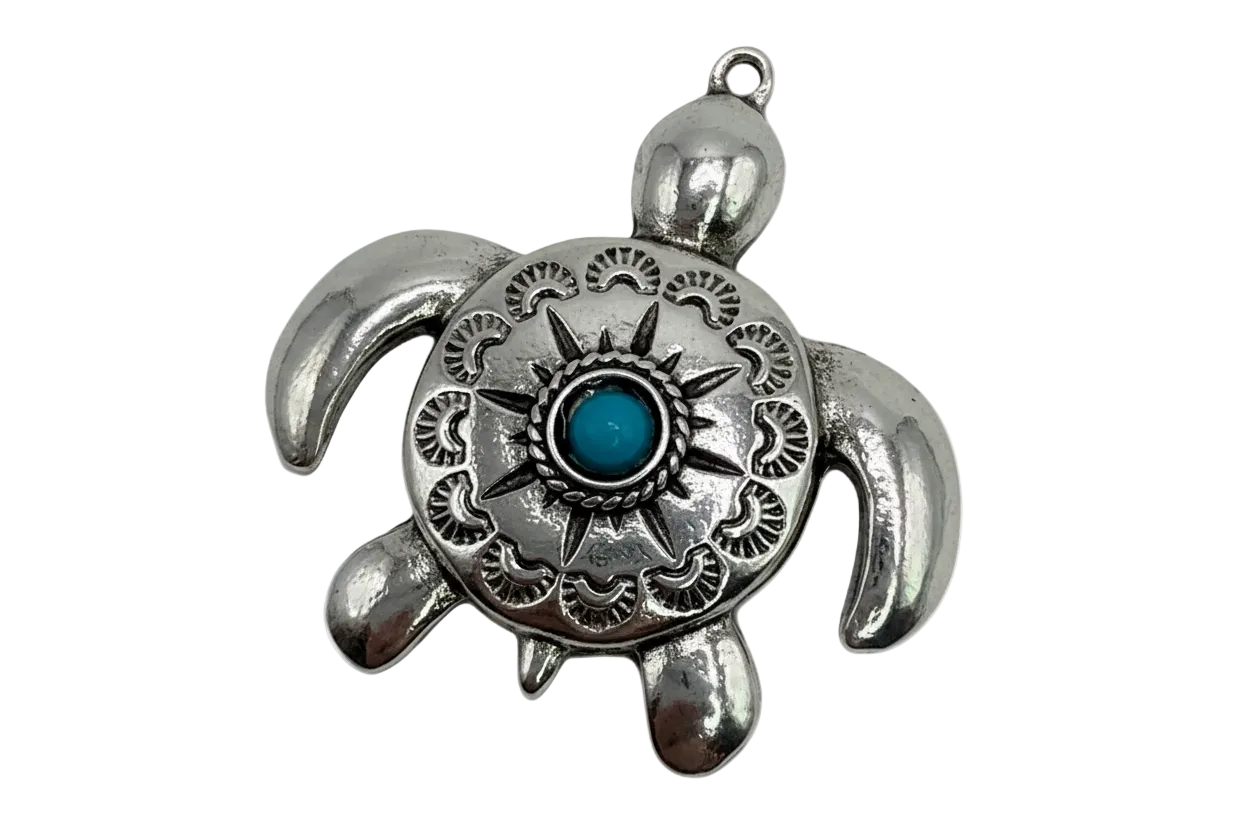 Polished silver-tone engraved sea turtle with sunburst detail and turquoise center gem