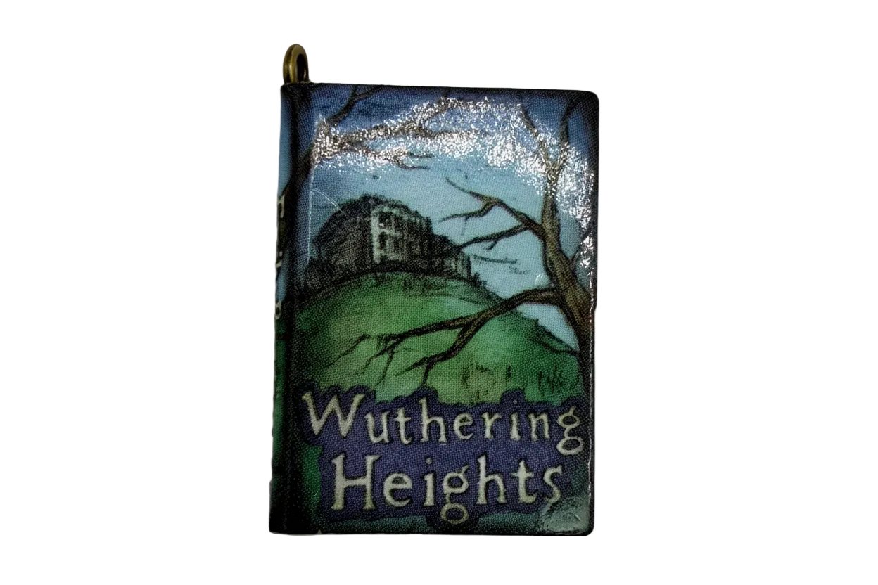 Mini book charm with blue sky, green hillside illustration, and gold-tone top bail