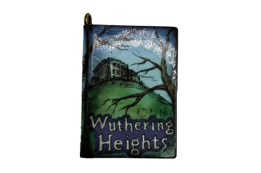 Mini book charm with blue sky, green hillside illustration, and gold-tone top bail