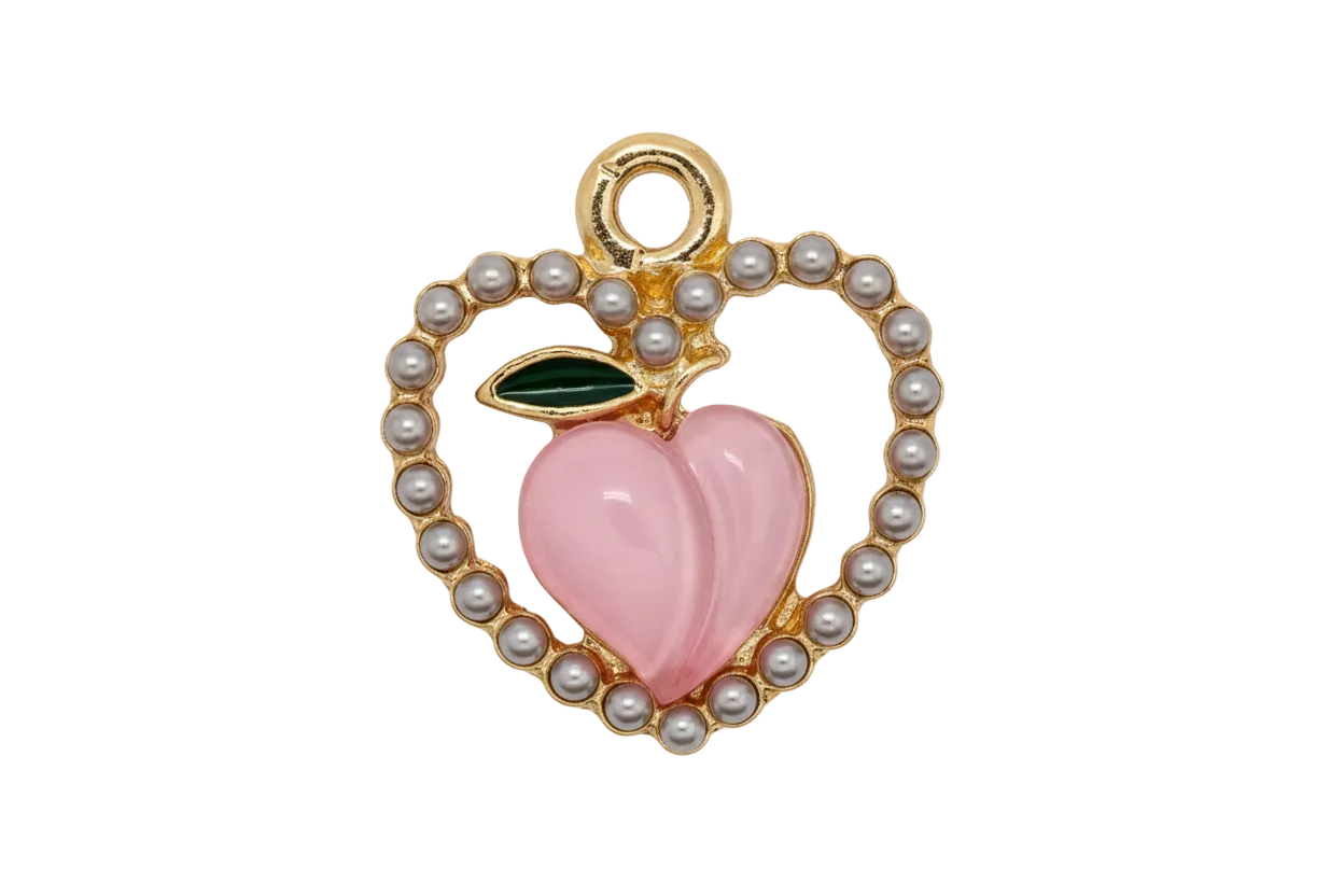 Gold apple charm with pearl border, pink heart center, and black leaf detail