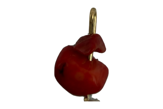 Glossy red organic sculptural charm with polished gold accent on black background