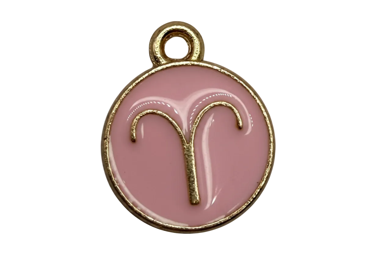 Blush pink round Aries zodiac medallion with raised gold symbol