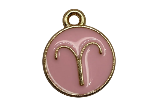 Blush pink round Aries zodiac medallion with raised gold symbol