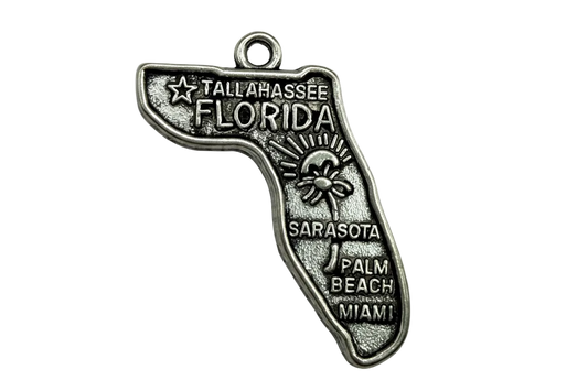 Antiqued silver Florida state map charm with raised city names and sun-and-palm detail