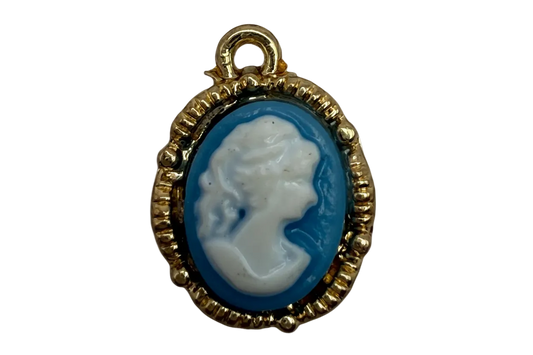 Gold-framed oval cameo with white profile portrait on deep blue background