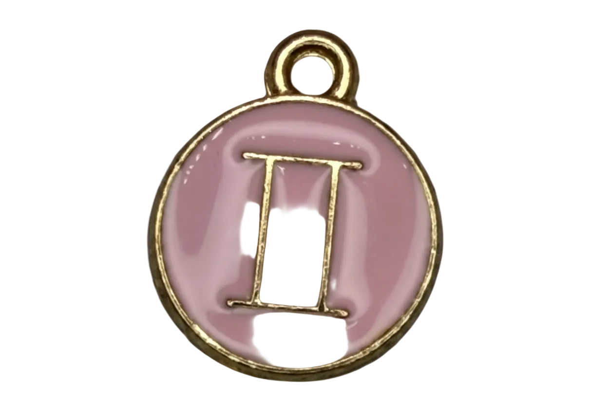 Pink enamel Gemini symbol medallion in gold with a small clear gem accent