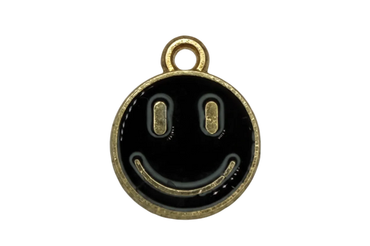 Round black enamel smiley face charm with gold trim and clear gem accent