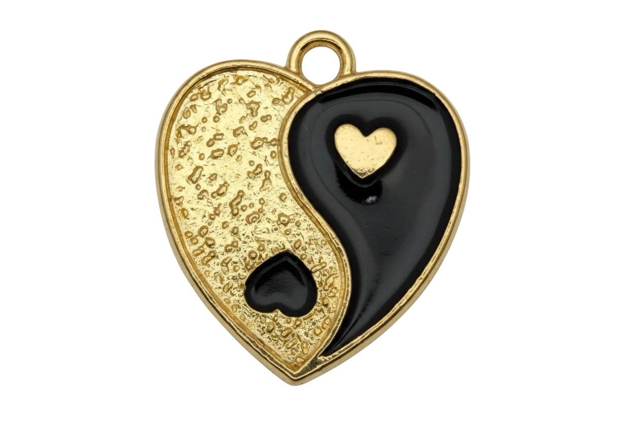 Two-tone yin-yang heart charm in textured gold and glossy black enamel with small contrasting hearts