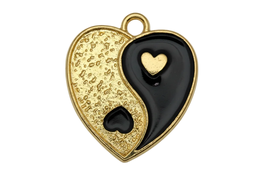 Two-tone yin-yang heart charm in textured gold and glossy black enamel with small contrasting hearts