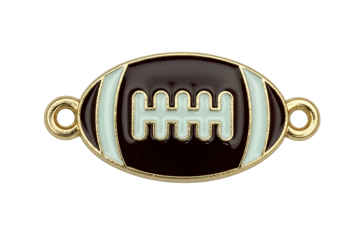 Black enamel football with white stripes and laces, gold outline, and small clear gem accents