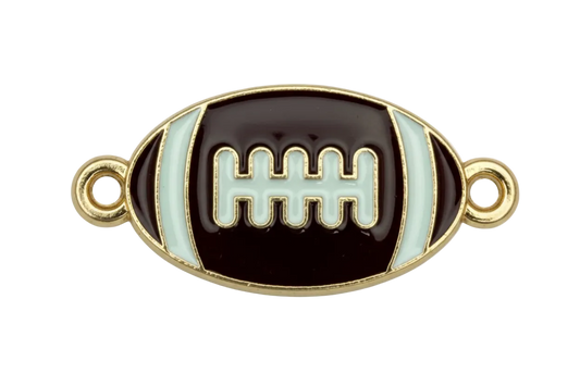 Black enamel football with white stripes and laces, gold outline, and small clear gem accents
