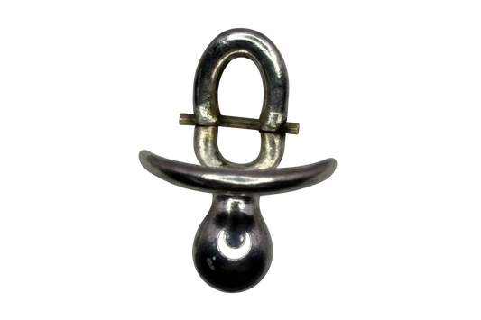 Polished silver pacifier silhouette with rounded contours on a black background