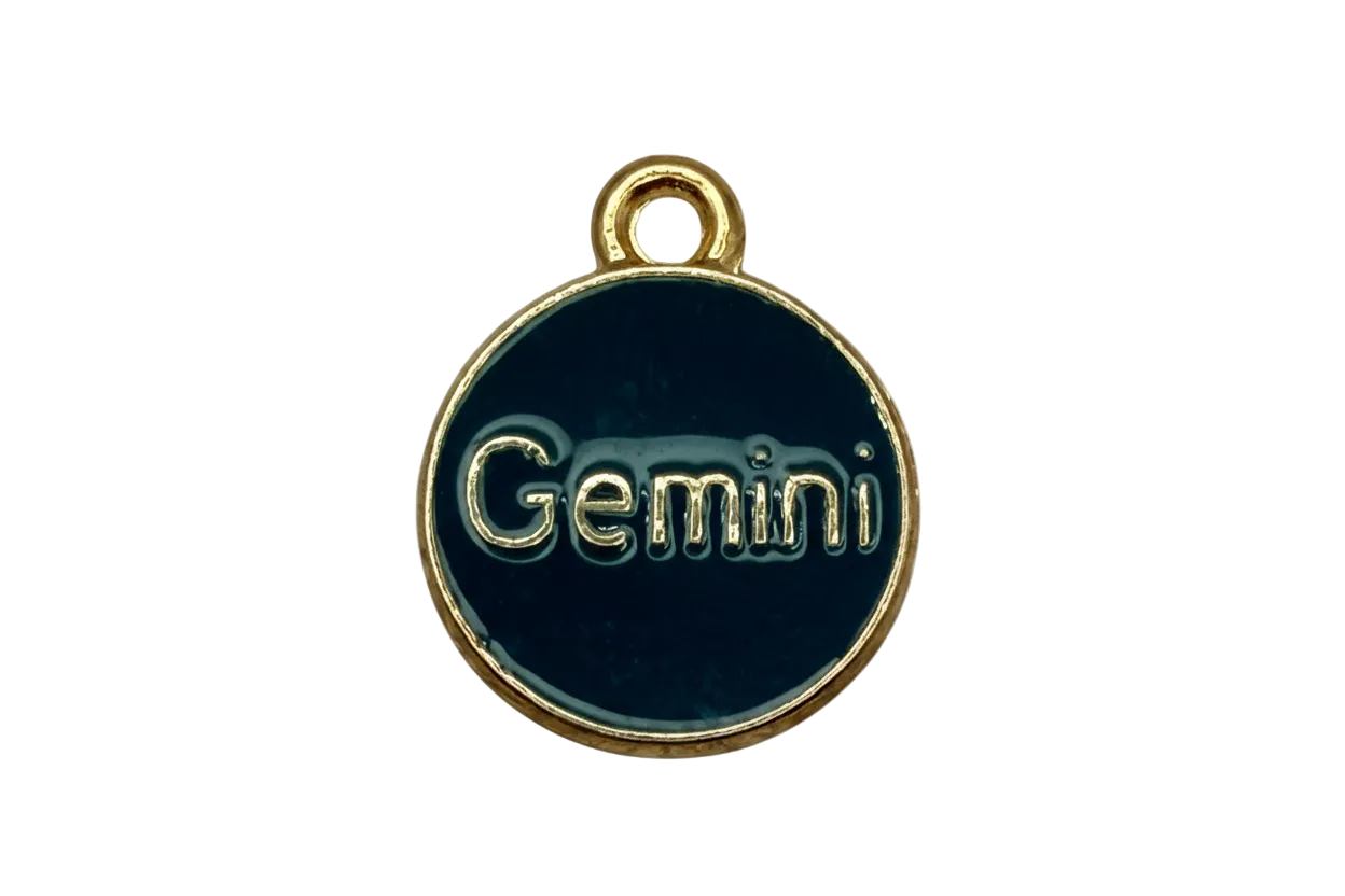 Dark teal enamel round disc with raised gold Gemini lettering and gold rim