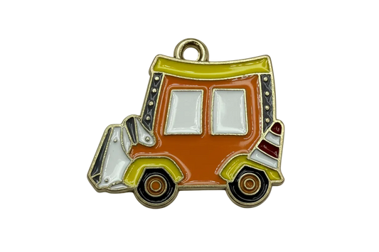 Glossy enamel retro food truck motif in orange with olive green trim, white windows, and black wheels on gold