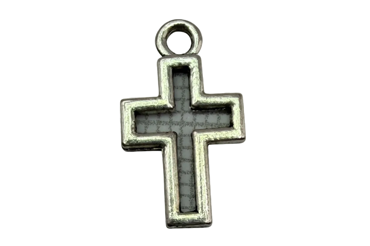 Antiqued silver cross with gray inlay and darkened detailing on black background