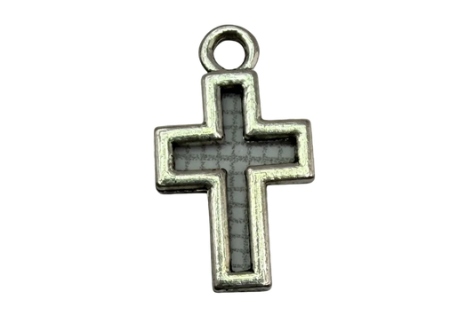Antiqued silver cross with gray inlay and darkened detailing on black background