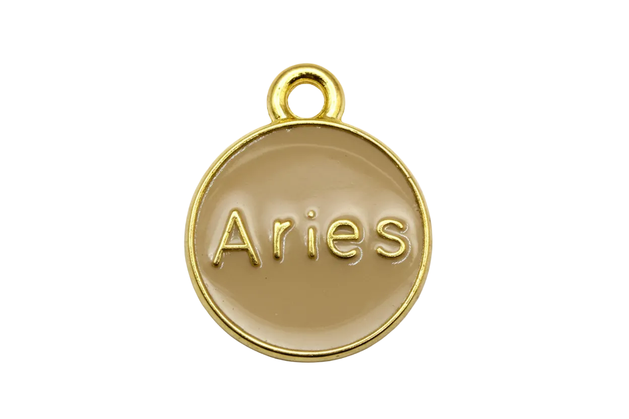 Round tan enamel Aries zodiac medallion with raised gold lettering and polished gold rim
