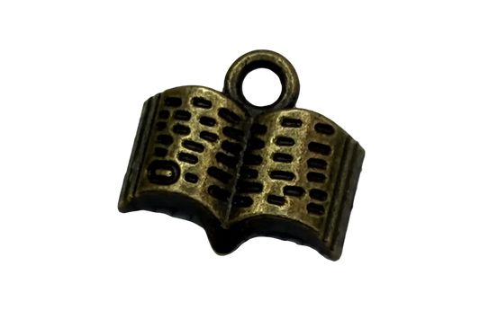 Antique gold open book charm with dark recessed details and textured pages