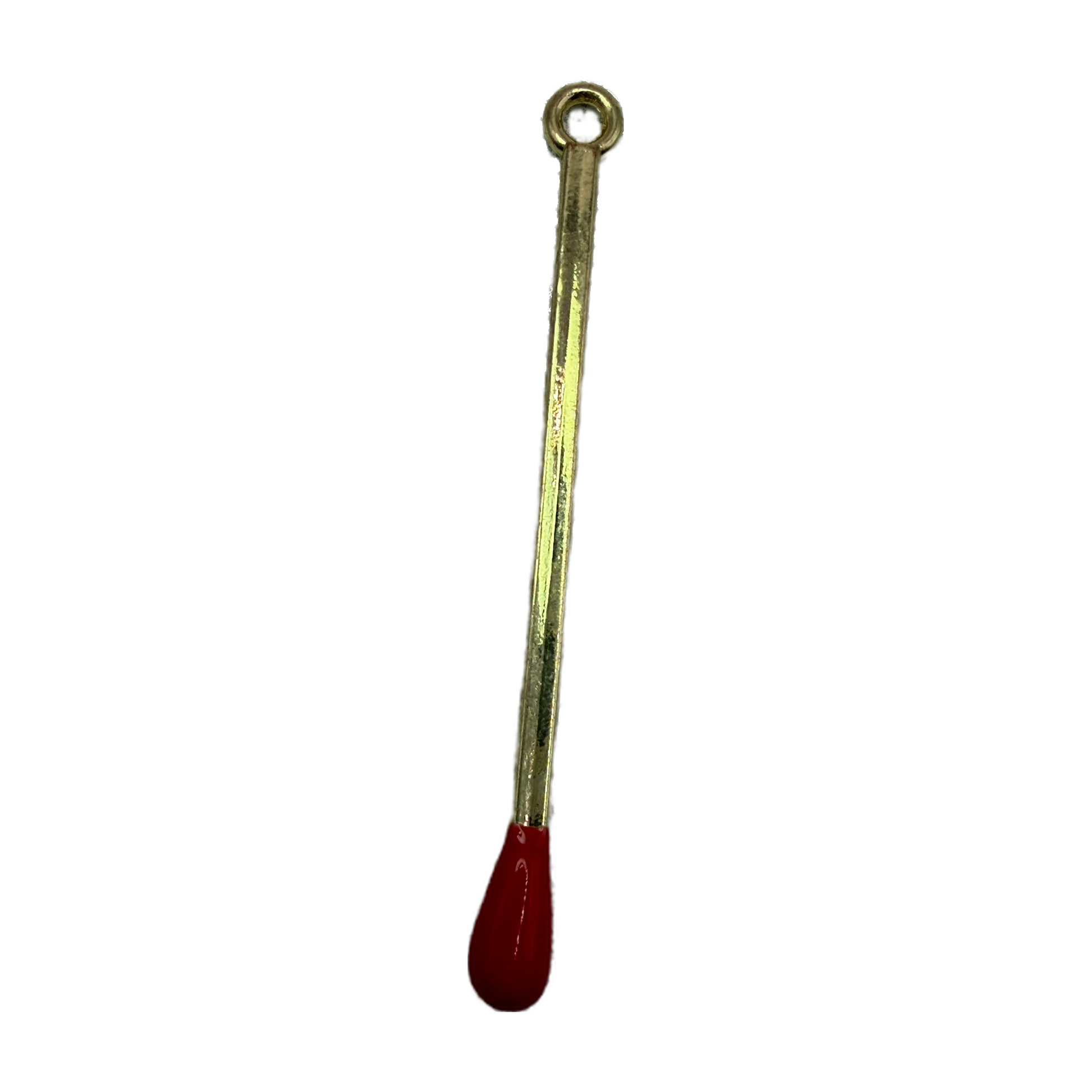 Polished gold matchstick charm with glossy red tip on black background
