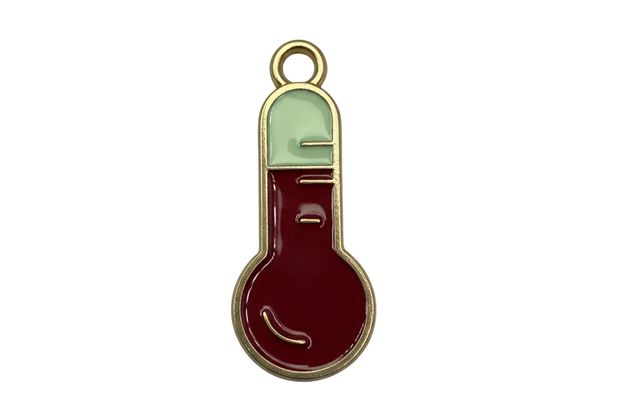 Gold-outlined red and ivory enamel stocking charm with glossy finish