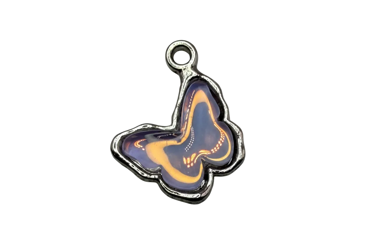 Purple butterfly pendant with golden swirls and silver-tone outline on black background