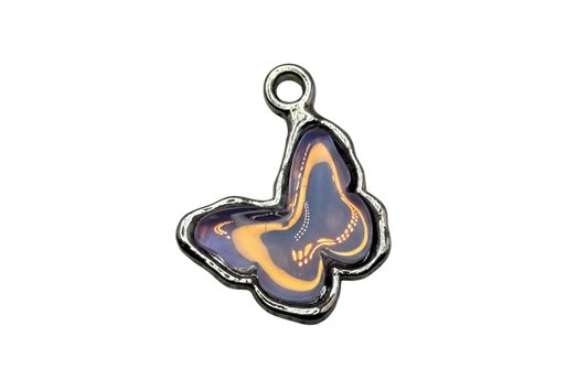 Purple butterfly pendant with golden swirls and silver-tone outline on black background