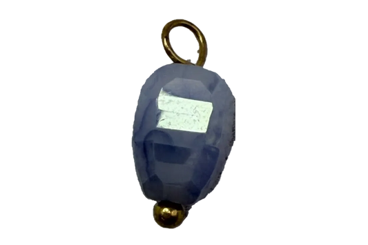Faceted midnight blue oval gem charm with gold accents