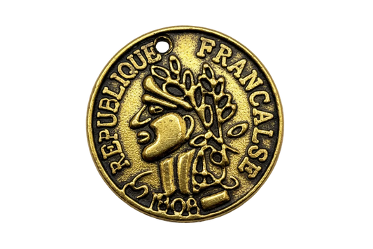 Antiqued gold coin-style medallion with raised French lettering and profile portrait