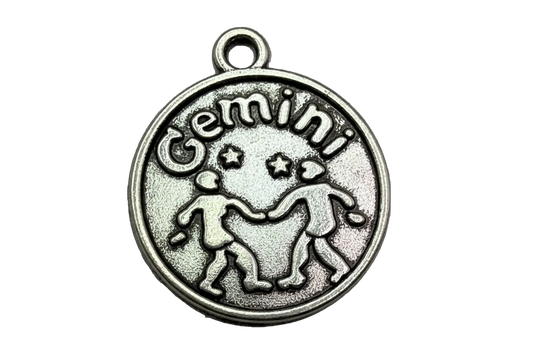 Antiqued silver Gemini zodiac round medallion with raised twins and Gemini lettering