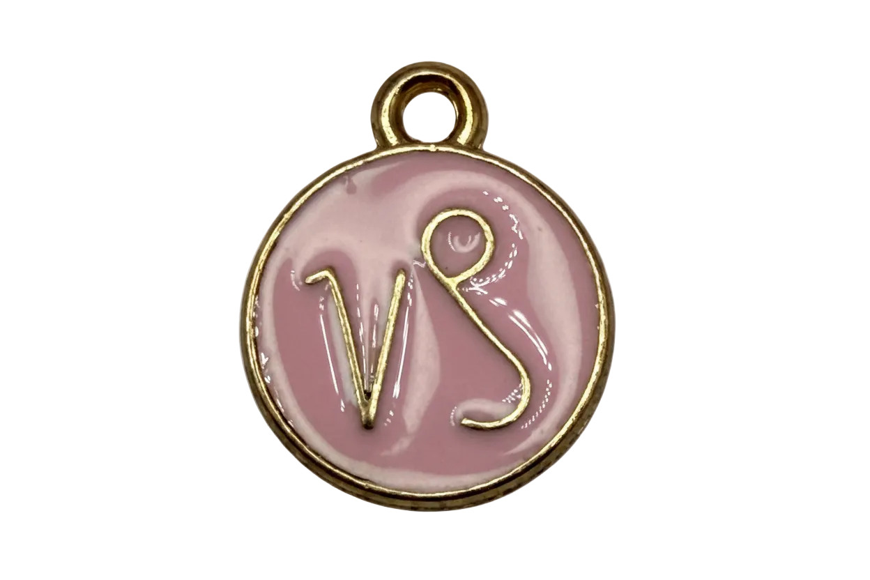 Round blush-pink enamel disc with raised gold VS lettering and polished gold rim