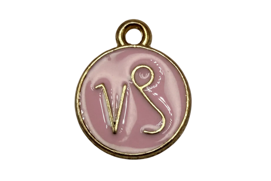 Round blush-pink enamel disc with raised gold VS lettering and polished gold rim