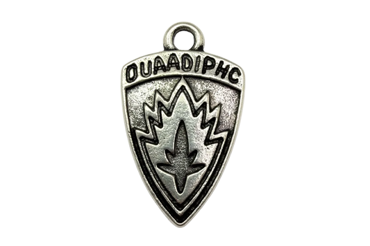 Antiqued silver-tone shield emblem with raised lettering and a stylized flame motif