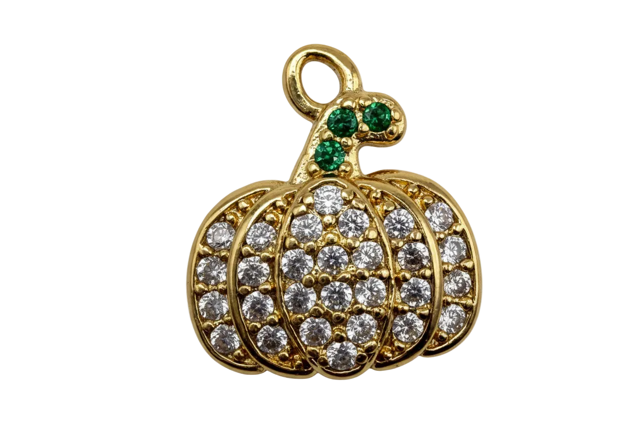 Gold pavé crystal pumpkin charm with green gem stem on black background