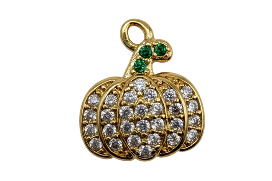 Gold pavé crystal pumpkin charm with green gem stem on black background