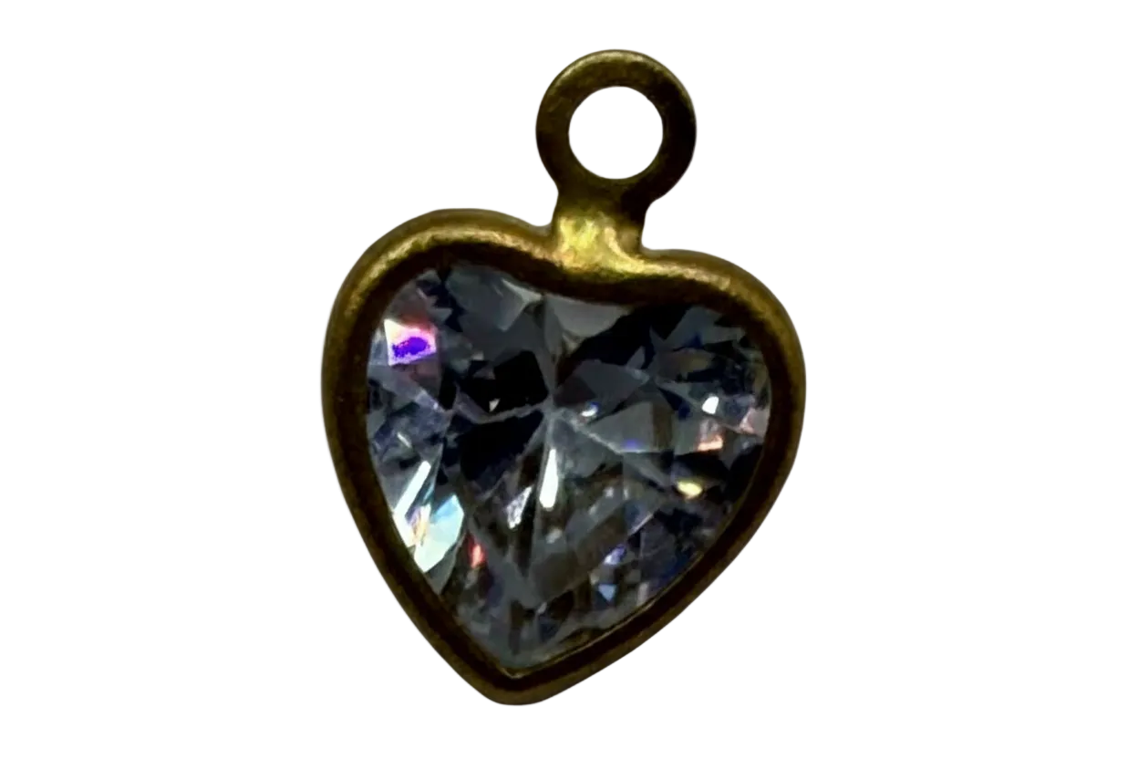 Faceted clear heart-shaped gem in a gold frame with iridescent highlights