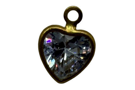 Faceted clear heart-shaped gem in a gold frame with iridescent highlights