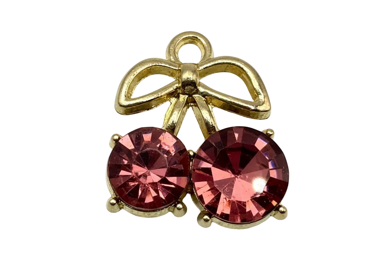 Gold ribbon bow charm with two round faceted pink gems