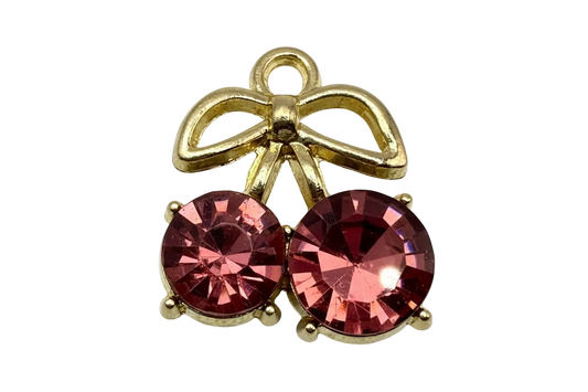 Gold ribbon bow charm with two round faceted pink gems