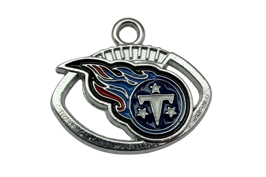 Silver-tone enamel emblem with navy flame design, letter T, and star details