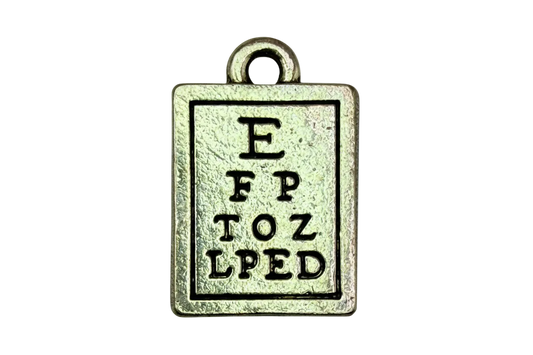 Antiqued silver rectangular eye chart tag with engraved letters and darkened outline