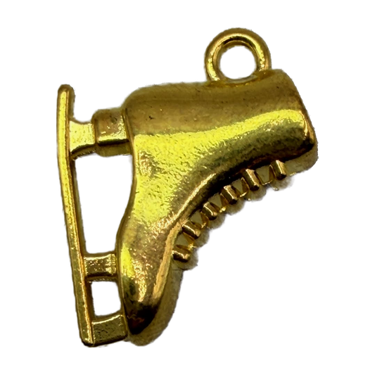 Gold ice skate charm with sculpted boot and blade details on black background