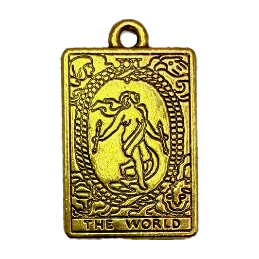 Gold rectangular World tarot card pendant with engraved dancing figure, oval wreath, and THE WORLD text